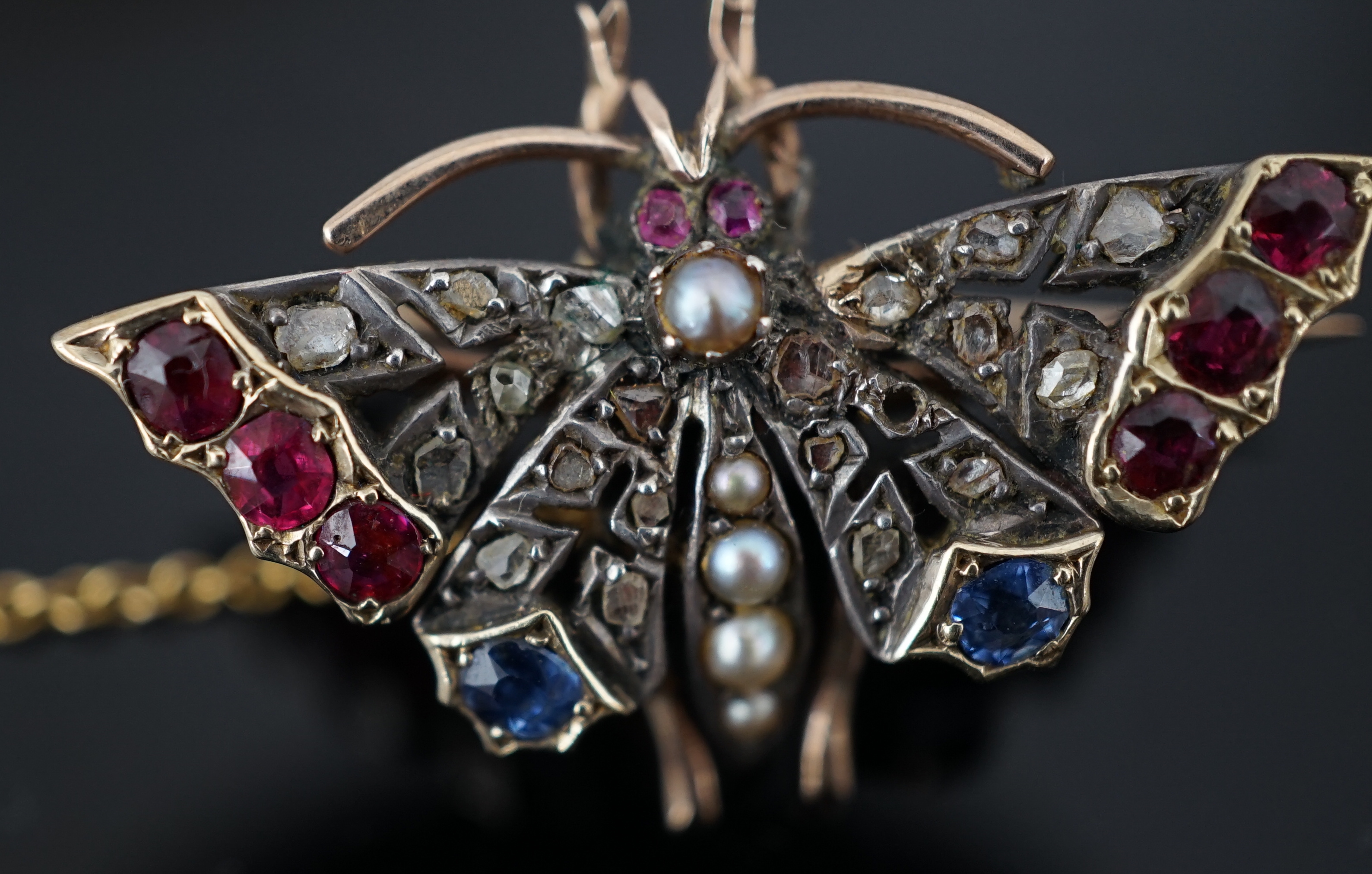A Victorian gold, ruby, sapphire, split pearl and diamond cluster set butterfly brooch